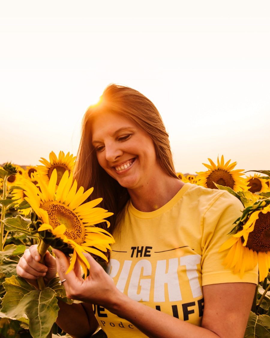 Melissa Bright smiling in a sunflower field
